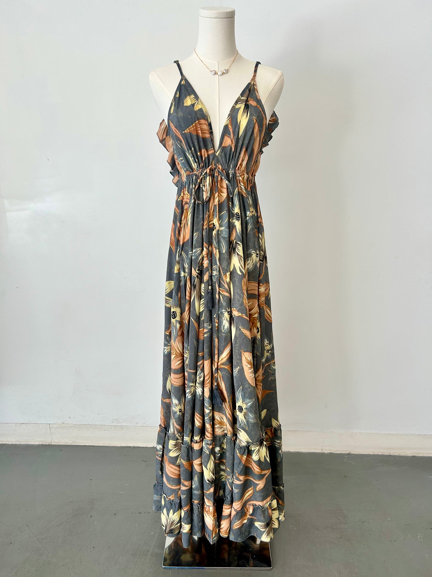 Floral patterned dress on a mannequin against a white background